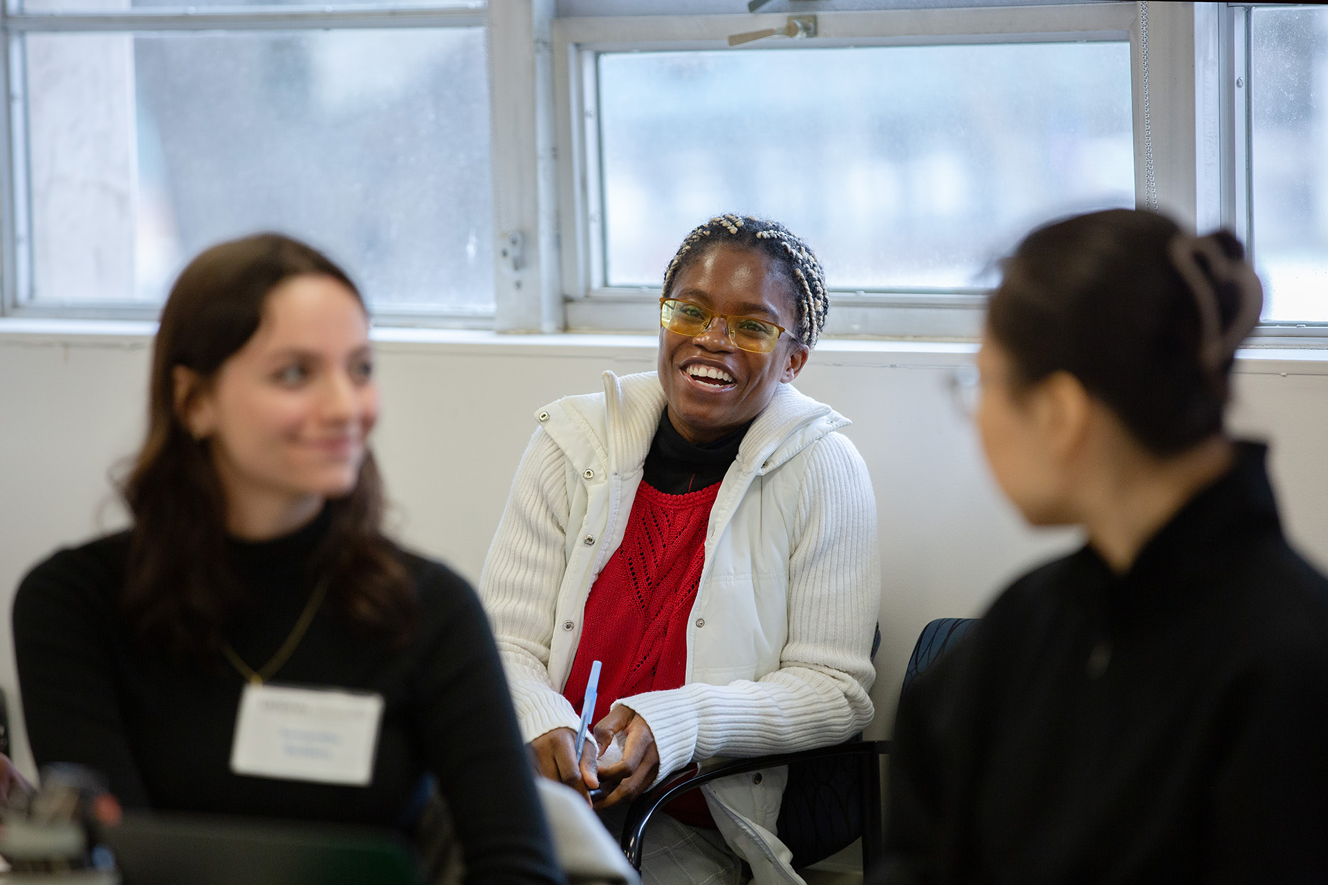 A student smiles during a graduate communication class.