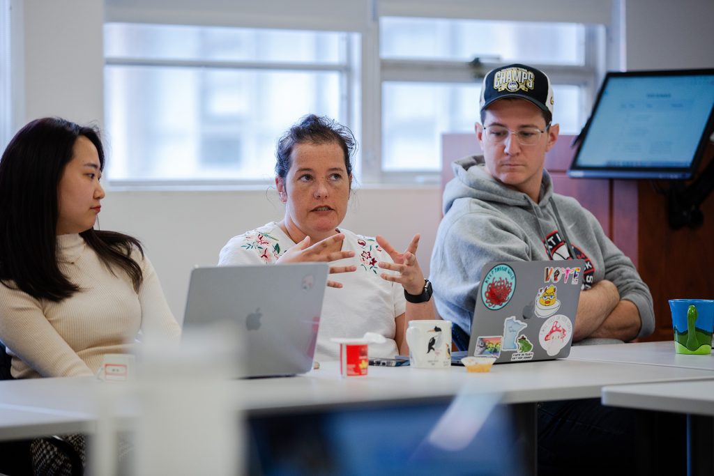 A student talks to the group during a graduate communication class.